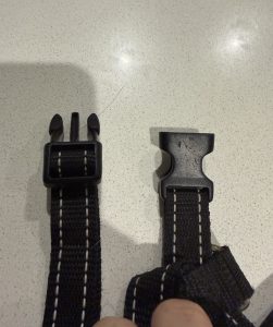 Plastic side-release buckle beside a metal quick-release buckle on a tactical harness
